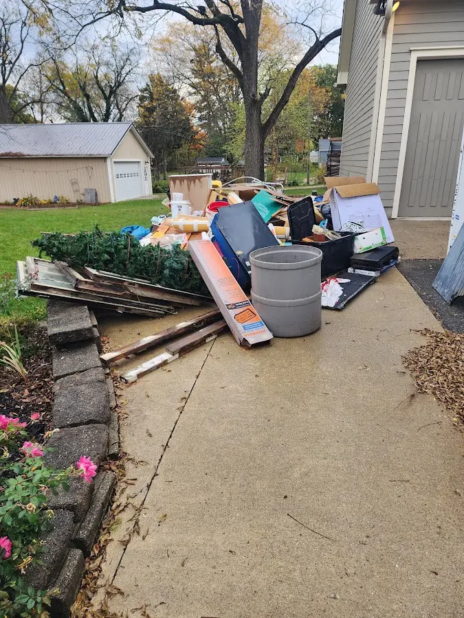 Dumpster being loaded with debris for Estate Cleanout Dumpster Rental in Vado
